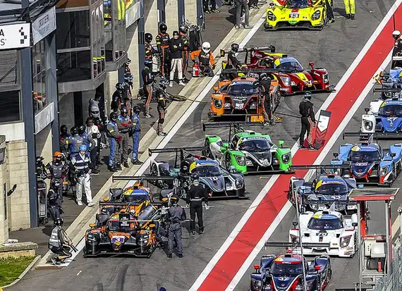 Teams preparing cars in the pit lane at the 2022 Le Mans Cup at Spa-Francorchamps, Belgium.