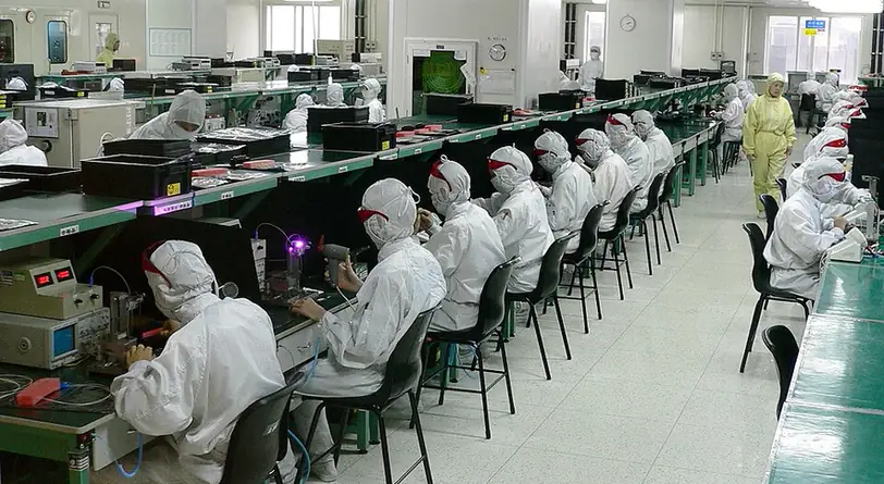 Workers manufacturing electronic components in Shenzhen, China, October 2005.